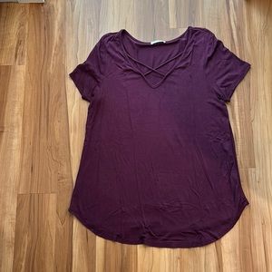 Purple tunic with a cutout x pattern at the neckline